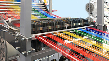 An industrial sewing machine sorting colours in a factory